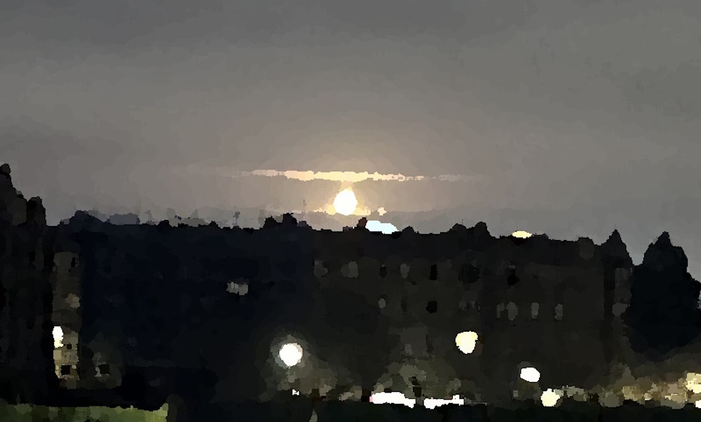 The moon above some tenements 